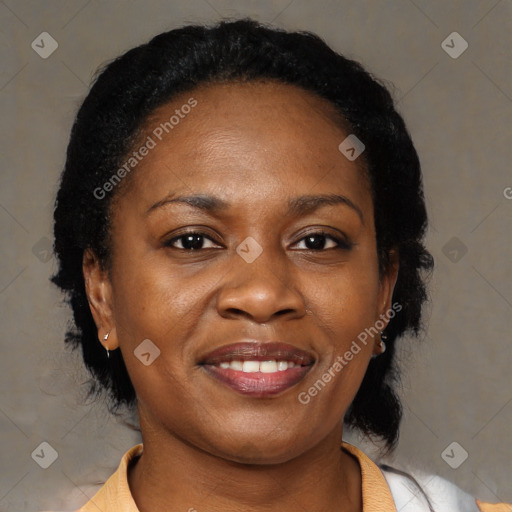 Joyful black adult female with medium  brown hair and brown eyes