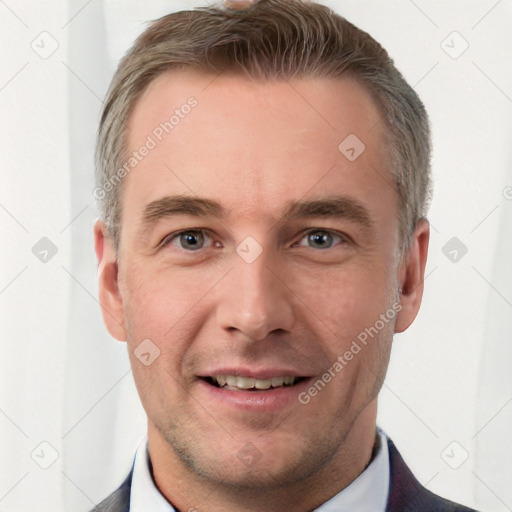 Joyful white adult male with short  brown hair and grey eyes