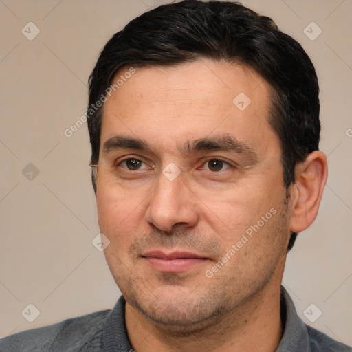 Joyful white adult male with short  black hair and brown eyes