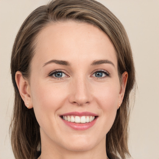 Joyful white young-adult female with long  brown hair and grey eyes