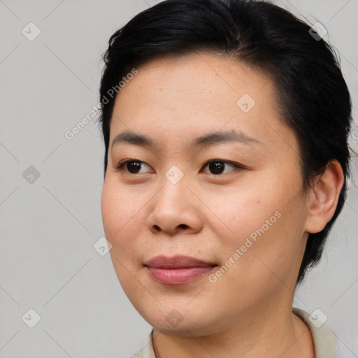 Joyful asian young-adult female with medium  brown hair and brown eyes