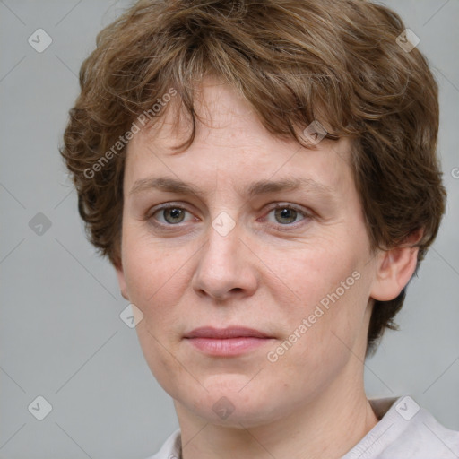 Joyful white adult female with medium  brown hair and blue eyes