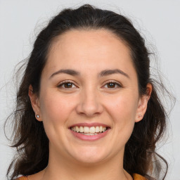 Joyful white adult female with medium  brown hair and brown eyes