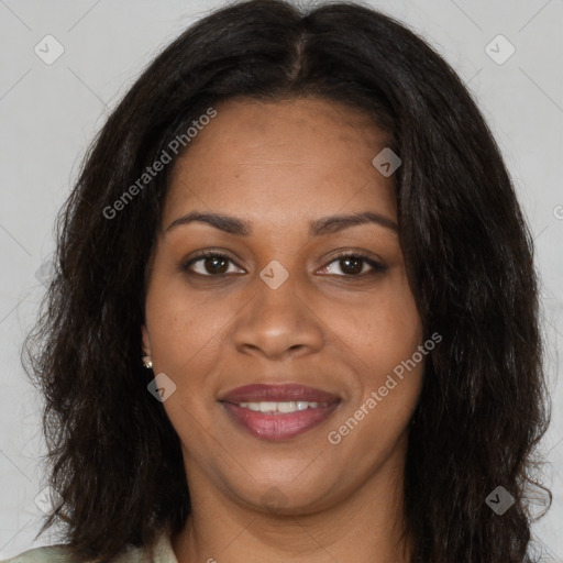 Joyful black young-adult female with long  brown hair and brown eyes