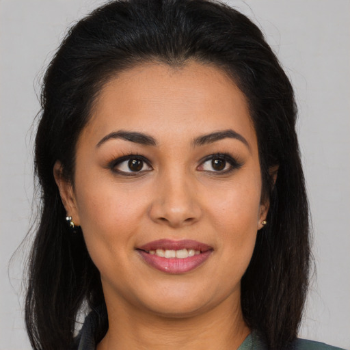 Joyful latino young-adult female with long  brown hair and brown eyes