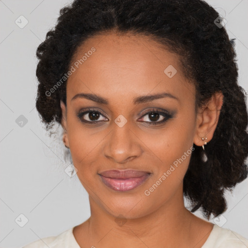 Joyful black young-adult female with long  brown hair and brown eyes