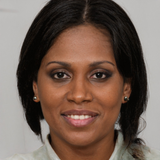 Joyful black young-adult female with medium  brown hair and brown eyes