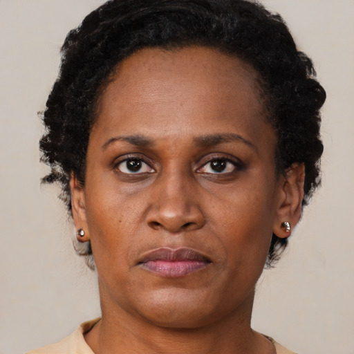 Joyful black adult female with short  brown hair and brown eyes