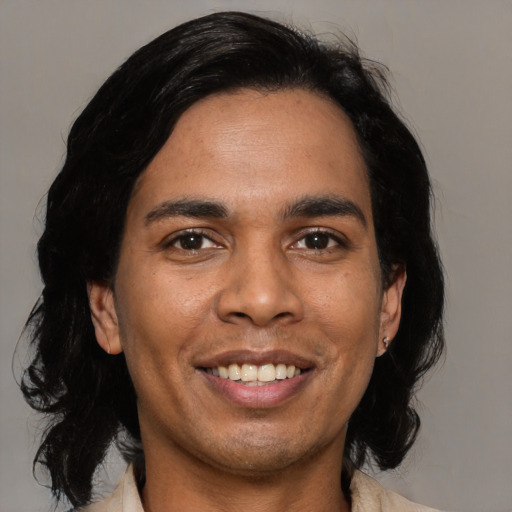 Joyful latino young-adult male with medium  black hair and brown eyes