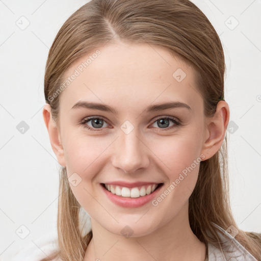 Joyful white young-adult female with long  brown hair and blue eyes