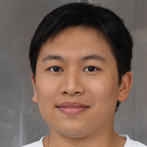 Joyful asian young-adult male with short  brown hair and brown eyes