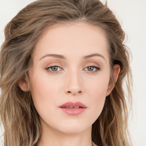 Joyful white young-adult female with long  brown hair and blue eyes