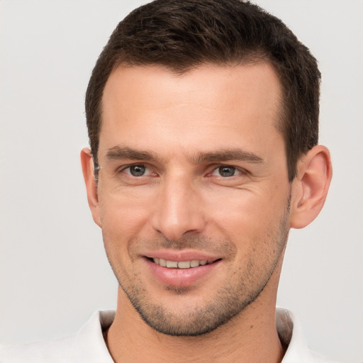 Joyful white young-adult male with short  brown hair and brown eyes