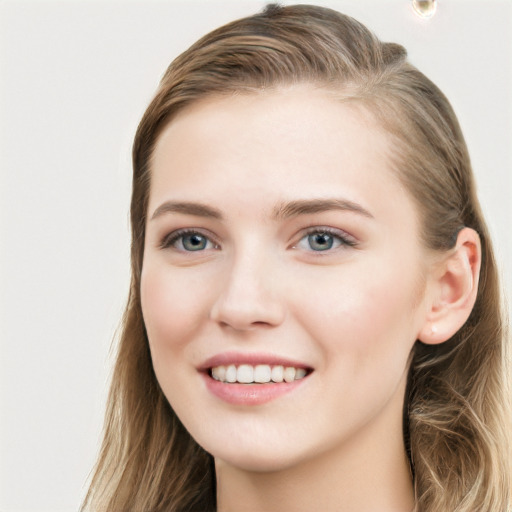 Joyful white young-adult female with long  brown hair and blue eyes