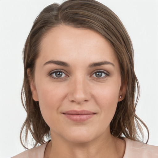 Joyful white young-adult female with medium  brown hair and grey eyes