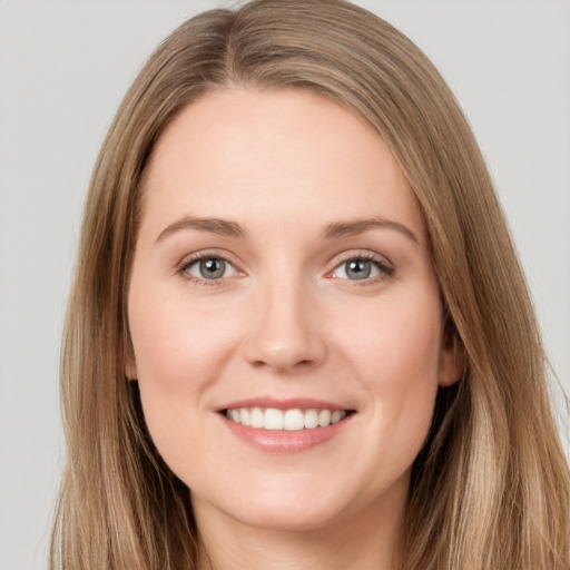 Joyful white young-adult female with long  brown hair and grey eyes