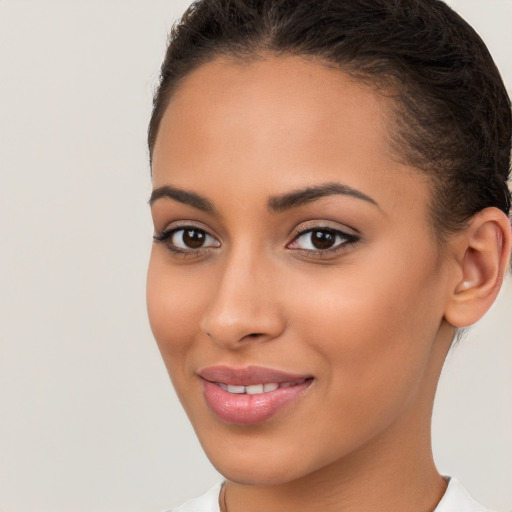 Joyful latino young-adult female with short  brown hair and brown eyes