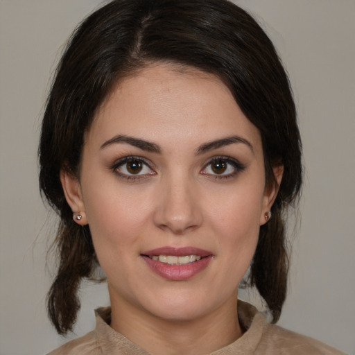 Joyful white young-adult female with medium  brown hair and brown eyes