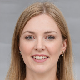 Joyful white young-adult female with long  brown hair and grey eyes