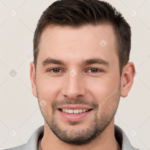 Joyful white young-adult male with short  brown hair and brown eyes