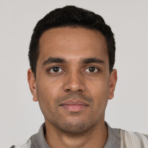 Neutral latino young-adult male with short  black hair and brown eyes