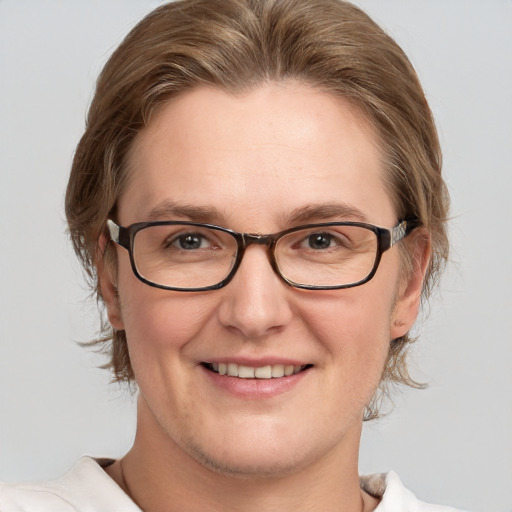 Joyful white adult female with medium  brown hair and grey eyes