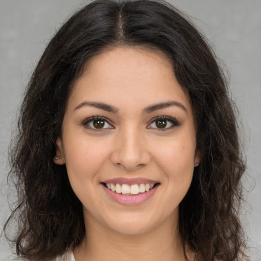 Joyful white young-adult female with long  brown hair and brown eyes