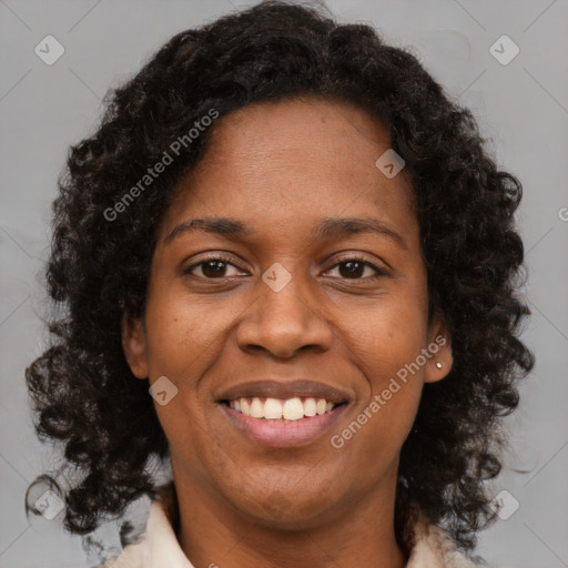 Joyful black young-adult female with medium  brown hair and brown eyes