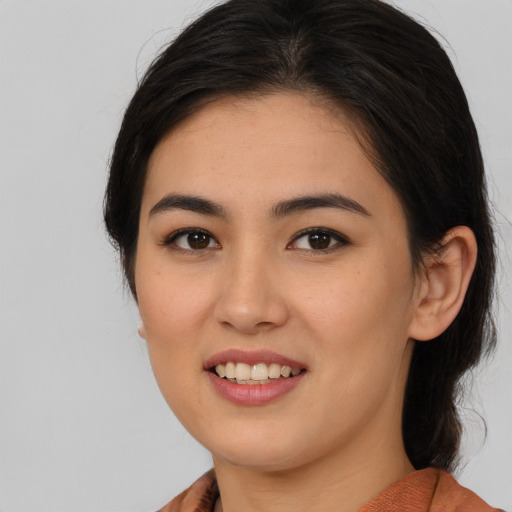 Joyful asian young-adult female with medium  brown hair and brown eyes