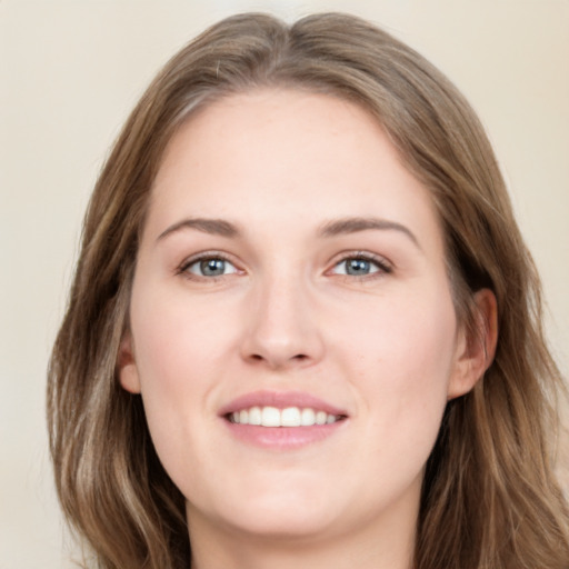 Joyful white young-adult female with long  brown hair and grey eyes