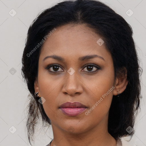 Joyful black young-adult female with long  brown hair and brown eyes