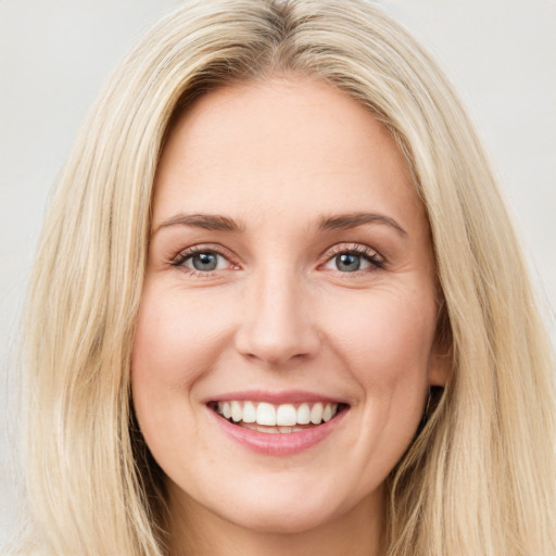 Joyful white young-adult female with long  brown hair and blue eyes