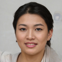 Joyful asian young-adult female with short  brown hair and brown eyes