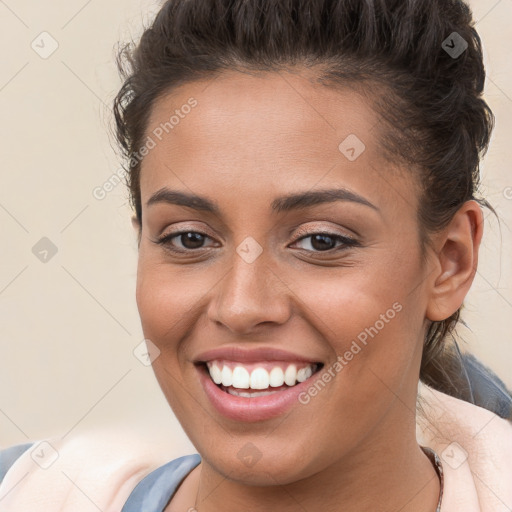 Joyful white young-adult female with short  brown hair and brown eyes