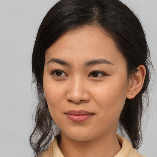 Joyful asian young-adult female with medium  brown hair and brown eyes