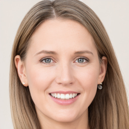 Joyful white young-adult female with long  brown hair and grey eyes