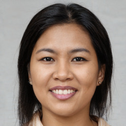 Joyful asian young-adult female with medium  brown hair and brown eyes