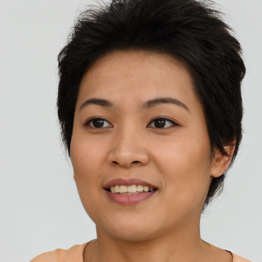 Joyful asian young-adult female with short  brown hair and brown eyes