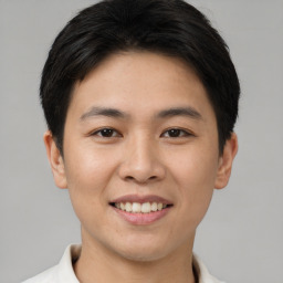 Joyful asian young-adult male with short  brown hair and brown eyes