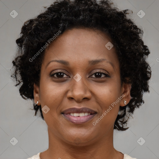 Joyful black adult female with short  brown hair and brown eyes