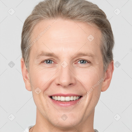 Joyful white adult male with short  brown hair and grey eyes