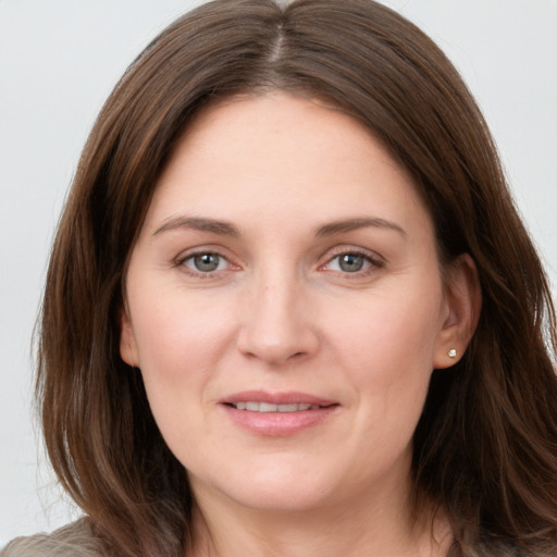 Joyful white young-adult female with long  brown hair and grey eyes