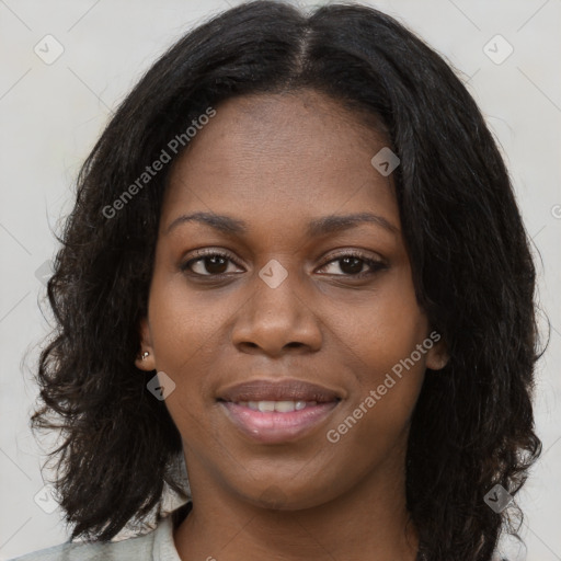 Joyful black young-adult female with long  black hair and brown eyes