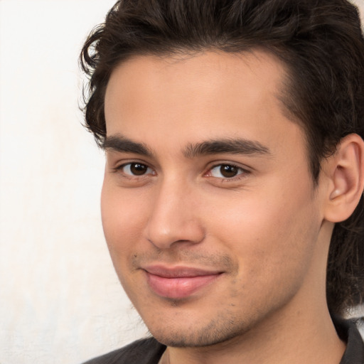 Joyful white young-adult male with medium  brown hair and brown eyes