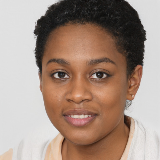 Joyful black young-adult female with short  brown hair and brown eyes