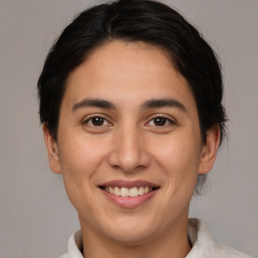 Joyful white young-adult female with short  brown hair and brown eyes