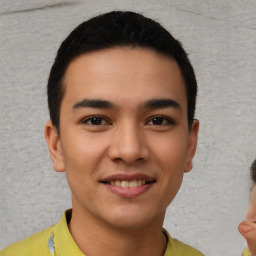 Joyful latino young-adult male with short  brown hair and brown eyes