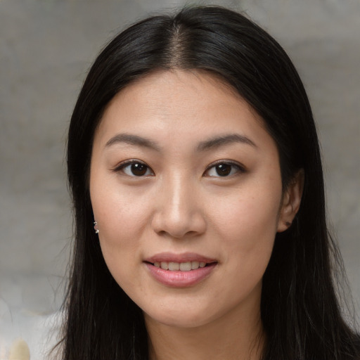 Joyful asian young-adult female with long  brown hair and brown eyes