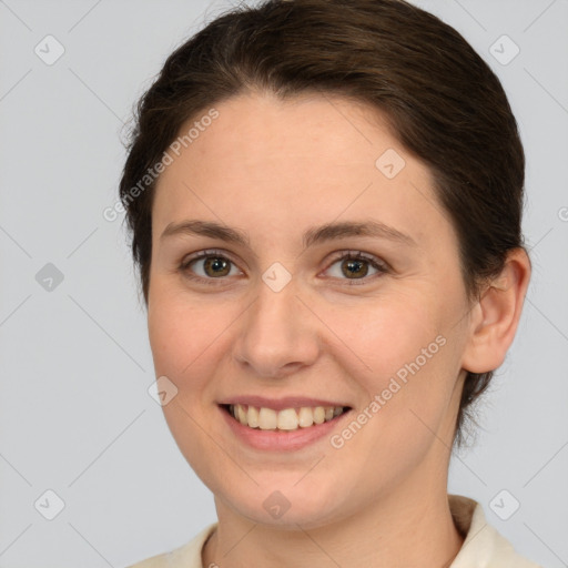 Joyful white young-adult female with medium  brown hair and grey eyes