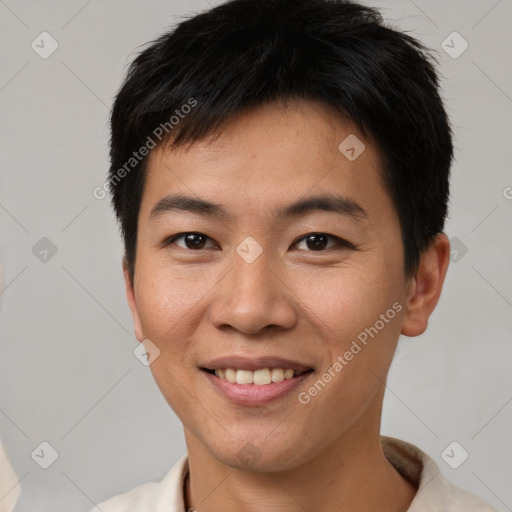 Joyful asian young-adult male with short  brown hair and brown eyes